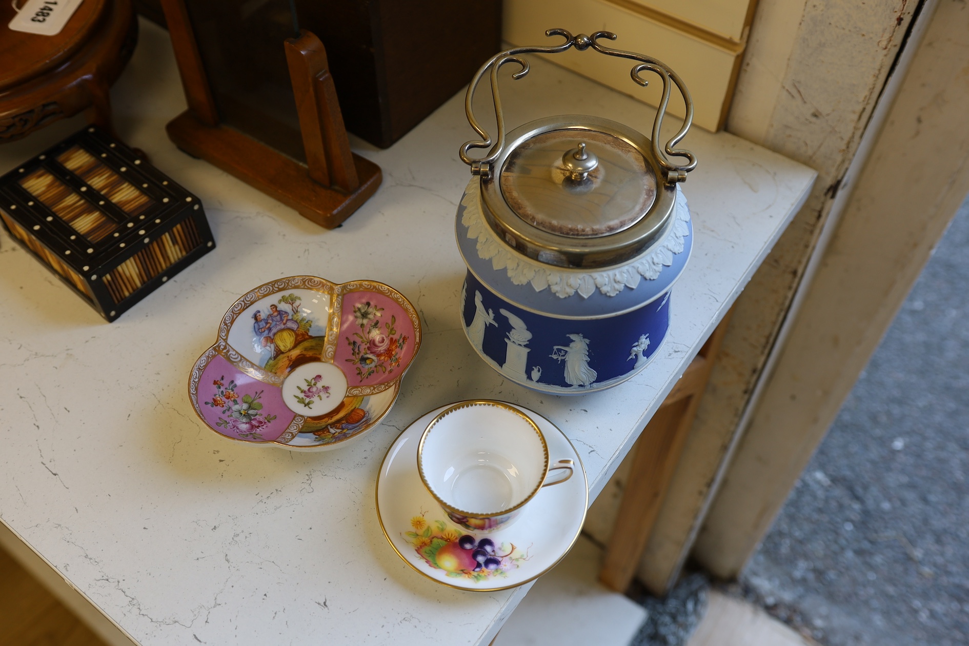 A Wedgwood three colour biscuit barrel with plated rim and handle, a Royal Worcester cup and saucer and a Dresden shaped bowl, biscuit barrel 17cm high. Condition - good